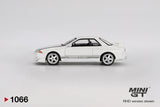 Side profile of Mini GT Nissan Skyline GT-R R32 VeilSide Combat C-I White showing the silver five spoke wheels, grey VeilSide graphics, modified front bumper and raised rear spoiler