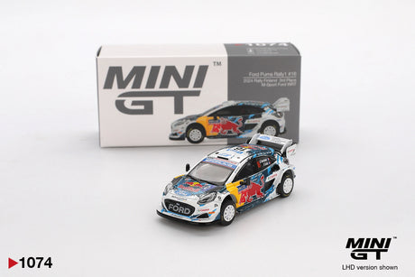 Mini GT Ford Puma Rally1 No.16 M-Sport Ford WRT 2024 Rally Finland diecast car with Red Bull racing graphics, white rally wheels and large rear wing, displayed in front of its Mini GT collector box
