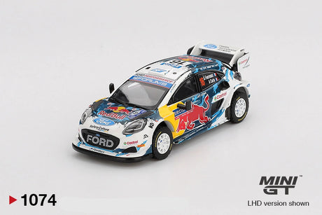 Mini GT Ford Puma Rally1 No.16 front three quarter view showing Ford grille, Red Bull bonnet graphics, white rally wheels, roof scoop and large rear wing