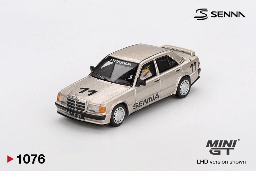 Mini GT Mercedes-Benz 190 E 2.3-16 No.11 Ayrton Senna 1984 diecast car in metallic gold, front three quarter view showing race number 11, SENNA graphics, silver wheels and Mercedes grille