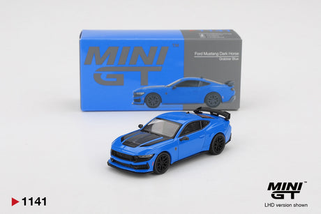 Mini GT Ford Mustang Dark Horse 2024 Grabber Blue diecast model with black bonnet graphics, black wheels and rear spoiler, displayed in front of its MINI GT collector box. LHD version shown.