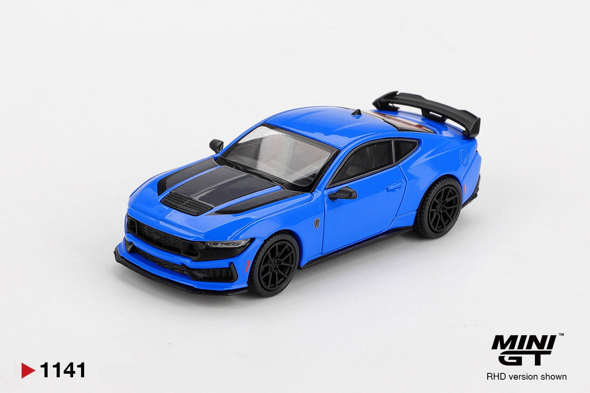 Front three quarter view of Mini GT Ford Mustang Dark Horse 2024 Grabber Blue RHD showing black bonnet graphics, wide front grille, black splitter, multi spoke wheels and rear spoiler.