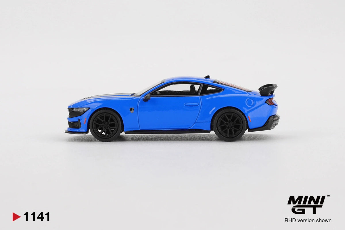 Side profile of Mini GT Ford Mustang Dark Horse 2024 Grabber Blue RHD showing blue coupe bodywork, black multi spoke wheels, front splitter and raised rear spoiler.