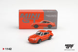 Mini GT Porsche 911 Carrera RS 2.7 Tangerine with Black Livery diecast car displayed in front of its MINI GT collector box, showing black Carrera graphics, black wheels and ducktail rear spoiler. LHD version shown.