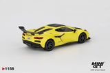 Rear three quarter view of Mini GT Chevrolet Corvette ZR1 Accelerate Yellow LHD showing the large black rear wing, Corvette lettering, four central exhaust outlets, black diffuser and rear lights.