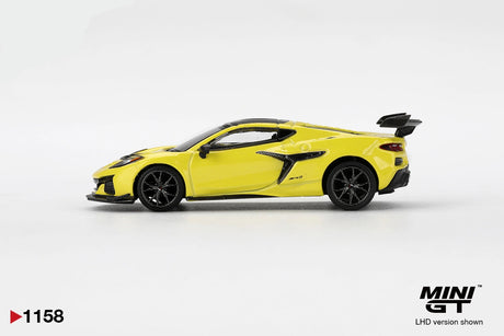 Side profile of Mini GT Chevrolet Corvette ZR1 Accelerate Yellow LHD showing yellow coupe bodywork, black multi spoke wheels, sculpted side air intake, front splitter and raised rear wing.