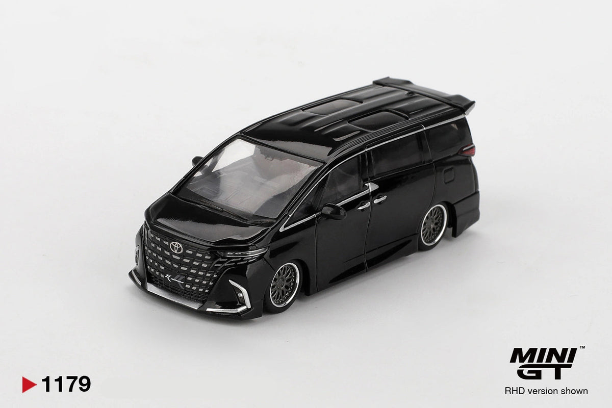 Front three quarter view of Mini GT Toyota Alphard 40 KUHL Black RHD showing the large Toyota front grille, custom front bumper, silver multi spoke wheels, roof detailing and lowered bodywork.