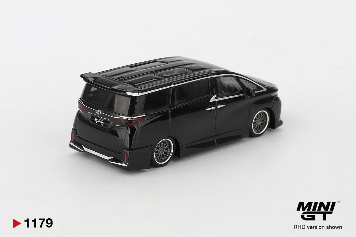 Rear three quarter view of Mini GT Toyota Alphard 40 KUHL Black RHD showing the rear roof spoiler, Toyota badge, Alphard lettering, custom rear bumper and silver multi spoke wheels.