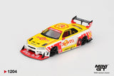 Mini GT Nissan LB-ER34 Skyline Suppaiman Okinawa front three quarter view showing the yellow bonnet with Japanese graphics, red front splitter, wide wheel arches, number 58 markings and black wheels