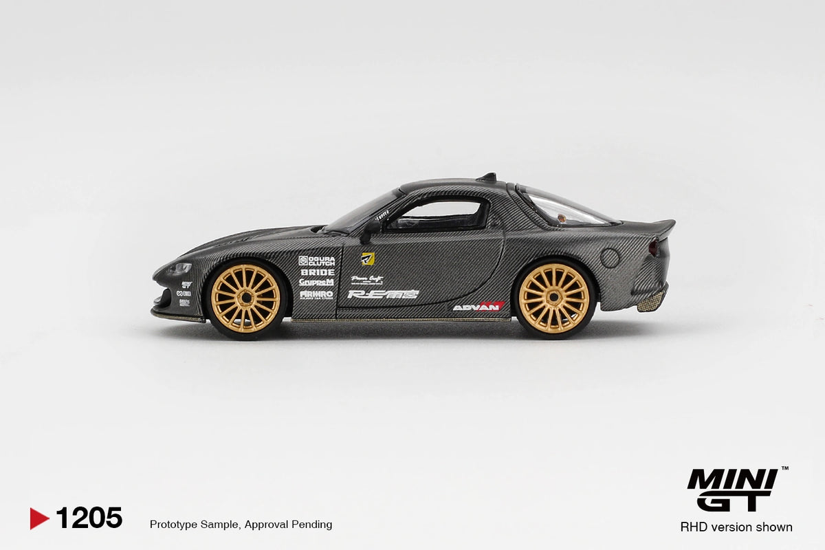Side profile of Mini GT Mazda RX-7 RE-Amemiya Matsukiyo KOKU 3 Rotor NA-7 showing carbon effect bodywork, gold multi spoke wheels, RE-Amemiya graphics and sponsor decals