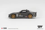 Side profile of Mini GT Mazda RX-7 RE-Amemiya Matsukiyo KOKU 3 Rotor NA-7 showing carbon effect bodywork, gold multi spoke wheels, RE-Amemiya graphics and sponsor decals
