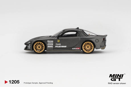 Side profile of Mini GT Mazda RX-7 RE-Amemiya Matsukiyo KOKU 3 Rotor NA-7 showing carbon effect bodywork, gold multi spoke wheels, RE-Amemiya graphics and sponsor decals