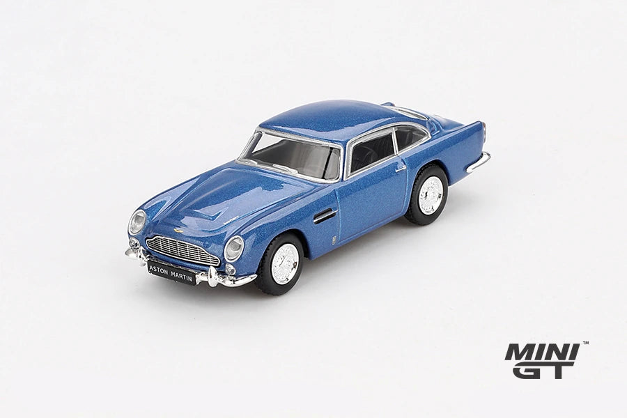 Mini GT Aston Martin DB5 Sierra Blue front three-quarter view showing the chrome grille, bumpers and wire-style wheels, LHD prototype shown
