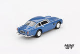 Mini GT Aston Martin DB5 Sierra Blue rear three-quarter view showing the chrome bumpers, rear lights and classic DB5 body shape, LHD prototype shown