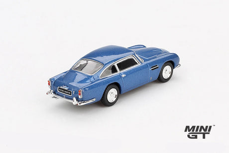 Mini GT Aston Martin DB5 Sierra Blue rear three-quarter view showing the chrome bumpers, rear lights and classic DB5 body shape, LHD prototype shown