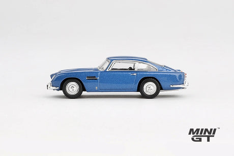 Mini GT Aston Martin DB5 Sierra Blue side profile showing the metallic blue body, chrome trim and wire-style wheels, LHD prototype shown