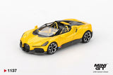 Mini GT Bugatti W16 Mistral Yellow LHD 1:64 diecast model viewed from the front, showing the Bugatti grille, black detailing, open cockpit and silver and black wheels