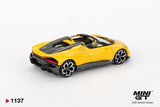 Rear three quarter view of Mini GT Bugatti W16 Mistral Yellow LHD showing the red rear light strip, black diffuser, yellow bodywork and open cockpit