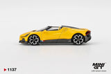 Side profile of Mini GT Bugatti W16 Mistral Yellow LHD showing the yellow roadster body, black lower panels, silver and black wheels and rear air intake