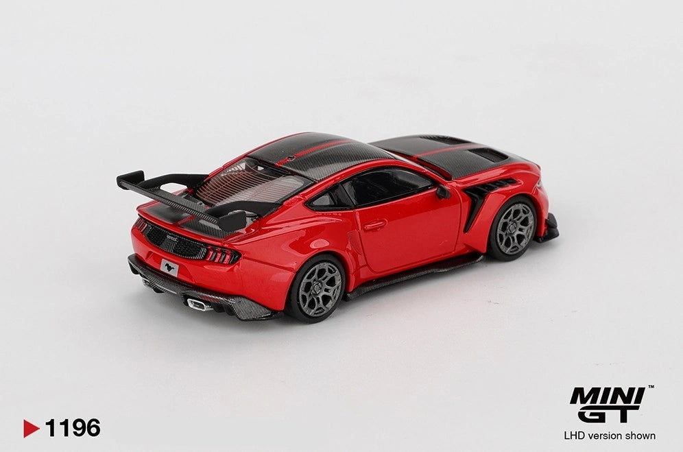 Rear three-quarter view of Mini GT Ford Mustang GTD Race Red LHD showing the large black rear wing, Mustang badge, triple-bar taillights, rear diffuser and black roof.
