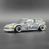 Mini GT Honda Civic EF Kaido Manga V1 front three-quarter view showing yellow headlights, alloy wheels and manga graphics