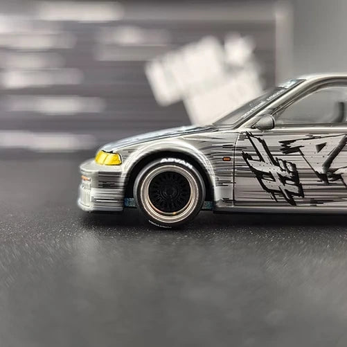Mini GT Honda Civic EF Kaido Manga V1 close-up showing the front wheel, yellow headlight and manga side graphics