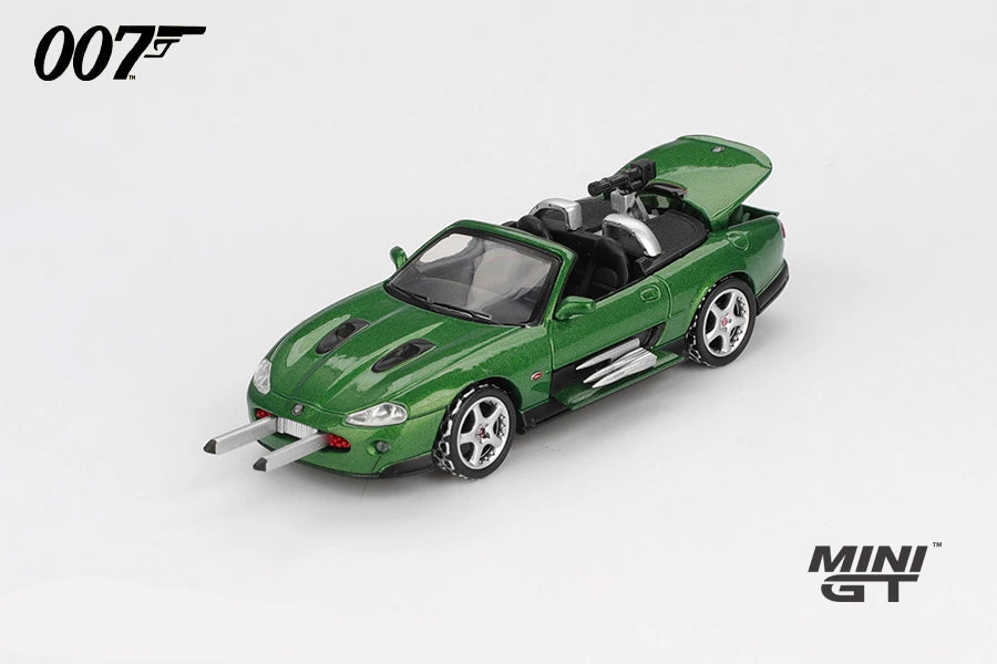 Mini GT James Bond Die Another Day Jaguar XKR green LHD prototype rear three quarter view with silver bars projecting from the front bumper, raised boot lid and rear mounted gun