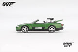 Mini GT James Bond Die Another Day Jaguar XKR green LHD prototype in side profile with raised boot lid and rear mounted gun