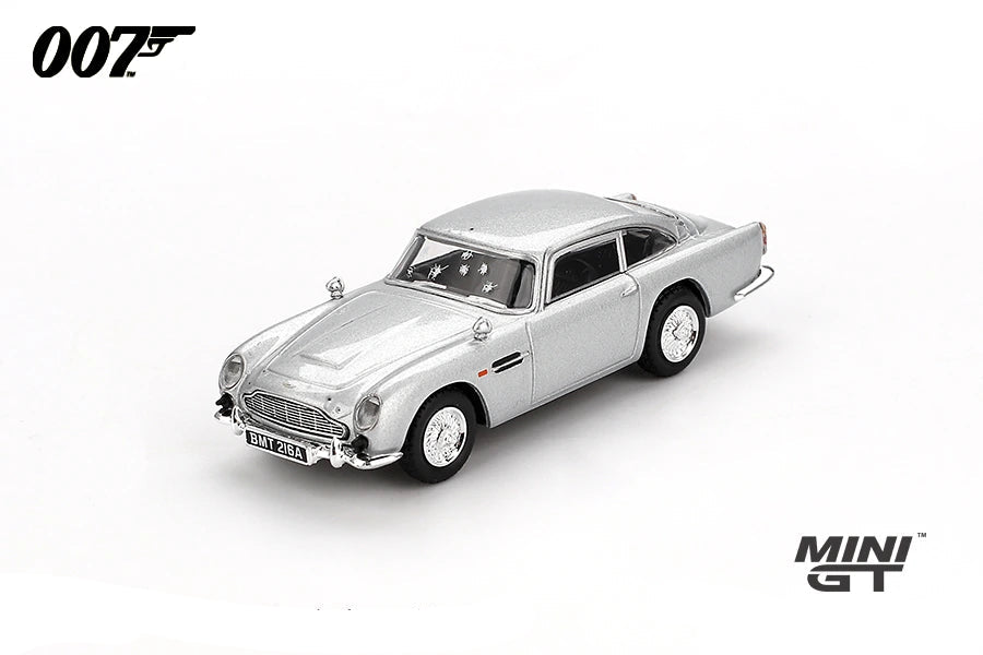 Mini GT James Bond Skyfall Aston Martin DB5 Battle Damaged RHD front three-quarter view showing damaged windows and bullet marks