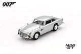 Mini GT James Bond Skyfall Aston Martin DB5 Battle Damaged RHD front three-quarter view showing damaged windows and bullet marks