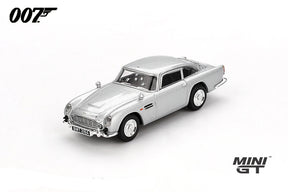 Mini GT James Bond Skyfall Aston Martin DB5 Battle Damaged RHD front three-quarter view showing damaged windows and bullet marks