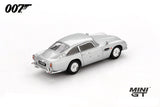Mini GT James Bond Skyfall Aston Martin DB5 Battle Damaged RHD rear three-quarter view showing bullet marks across the body and rear quarter