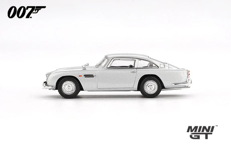 Mini GT James Bond Skyfall Aston Martin DB5 Battle Damaged side profile showing the Silver Birch body, wire style wheels and chrome trim