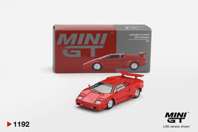 Mini GT Lamborghini Countach 25th Anniversary Red LHD 1:64 diecast model displayed with its collector box, showing the wedge shaped body, silver wheels, front headlights and rear wing.