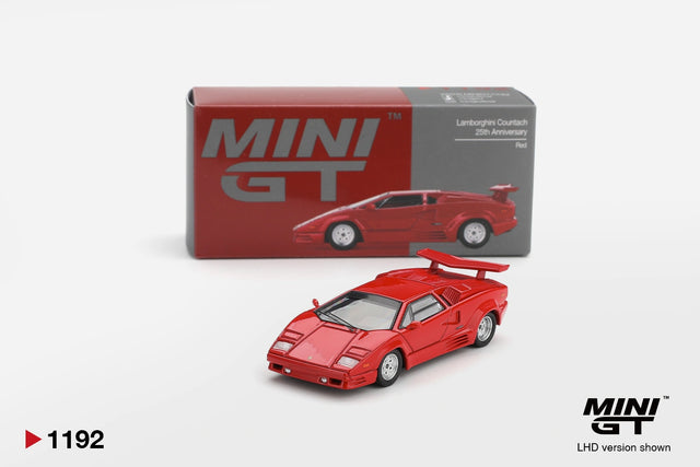 Mini GT Lamborghini Countach 25th Anniversary Red LHD 1:64 diecast model displayed with its collector box, showing the wedge shaped body, silver wheels, front headlights and rear wing.
