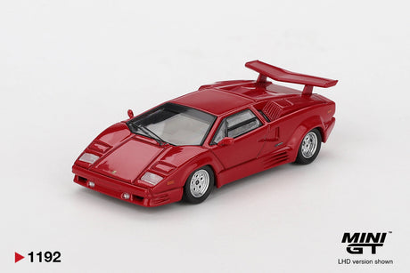 Front three-quarter view of Mini GT Lamborghini Countach 25th Anniversary Red LHD showing the angular bonnet, closed pop-up headlights, front bumper, side air intakes and raised rear wing.