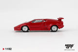 Side profile of Mini GT Lamborghini Countach 25th Anniversary Red LHD showing the low wedge shaped body, side air intakes, silver wheels, rear wing and red exterior finish.