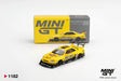 Mini GT Nissan LB-ER34 Super Silhouette Skyline Sport Yellow RHD 1:64 diecast model shown from the front with its collector box, Liberty Walk racing graphics, black wheels and large rear wing.