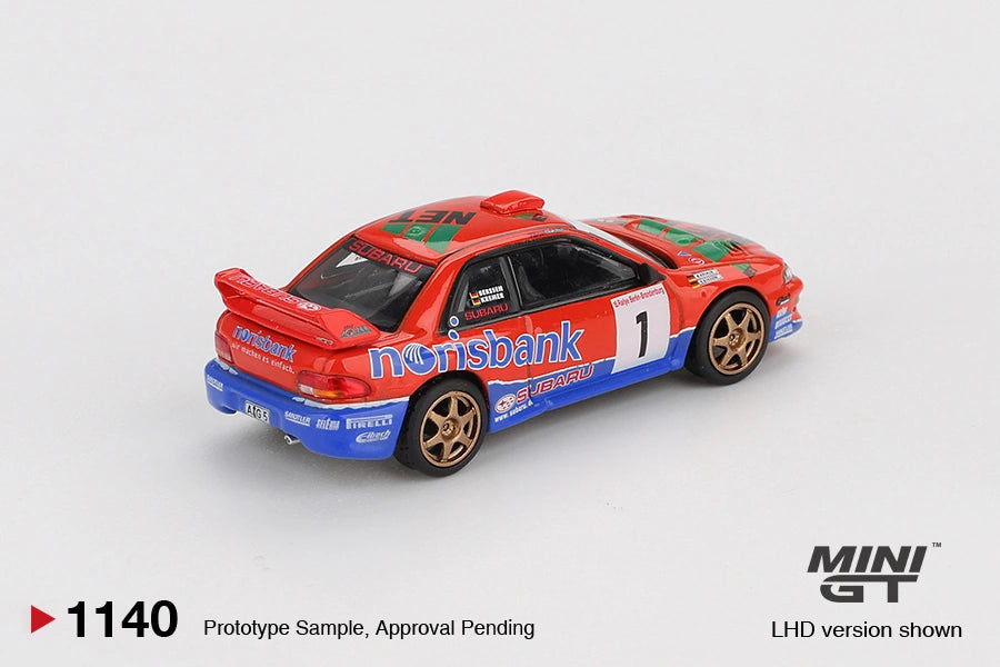 Rear three quarter view of Mini GT Subaru Impreza WRC97 No.1 1999 DRM Champion LHD showing the large rear wing, blue bumper, gold wheels and rally sponsor graphics