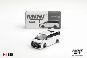 Mini GT Toyota Vellfire 40 KUHL White 1:64 diecast model shown from the front with its collector box, black grille and custom wheels. Promotional image labelled LHD version shown.