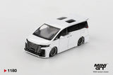 Front three-quarter view of Mini GT Toyota Vellfire 40 KUHL White RHD showing the large black Toyota grille, KUHL front bumper, lowered bodywork, custom wheels and twin roof windows.