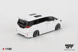 Rear three-quarter view of Mini GT Toyota Vellfire 40 KUHL White RHD showing the rear spoiler, Vellfire badging, KUHL rear window graphics and custom wheels.