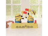 Hand pressing the red button on a Minions Hammer POP game with two Minions holding hammers