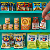 Miniature SPAM packets, Dole pineapple cans, Honey Bunches of Oats cereal, Tapatío hot sauce, Pirate's Booty snacks and SkinnyPop popcorn arranged on turquoise shelves, with a hand lifting a tiny hot sauce bottle.