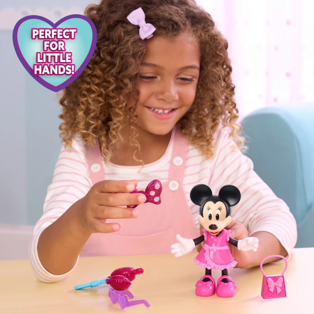 Child playing with Minnie Mouse Fabulous Fashion Doll and accessories