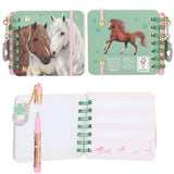 Miss Melody mini notebook with brown and white horses on the cover, a horse illustration on the back, open lined pages and a pink pen.