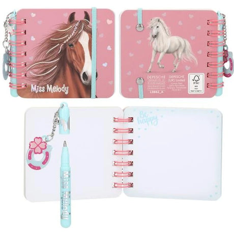 Miss Melody mini notebook with a chestnut horse on the cover, a white horse on the back, open notebook pages and a blue pen.