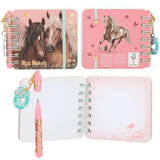 Miss Melody mini notebook with two horses on the cover, a standing horse on the back, an open notebook and a pink pen.