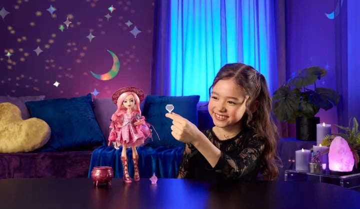 Monster High Moonspell Magic Carina Song doll and cauldron on table with child holding mirror