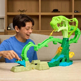 Child pushing a mini monster truck on the Monster Jam Cobra's Crazy Escape playset